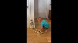 Watch as a sweet 3.5-year-old toddler prepares for Halloween with his life-size skeleton buddy, singing the