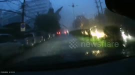 Roof blown onto power lines before falling onto cars in Thailand