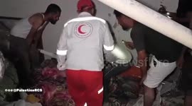 Palestine Red Crescent crews retrieve a martyr after the occupation forces bombed his home in the Al-Faluja area