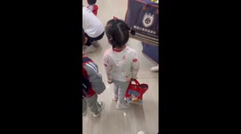 Calm child in crying kindergarten class gives V sign in Shaanxi Province, China