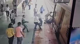 RPF Police saved a couple from falling between the platform and a moving train in Praygraj, Northern India