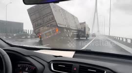 Tall trucks sway violently sway in strong winds as Typhoon Bebinca hits China