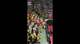 Energetic volleyball fans show their support with drums