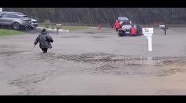 Good Samaritans bravely attempt to help a trapped driver and car in Jacksonville North Carolina flood waters.