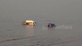 Desperate attempts to recover vehicles swept out to sea by rising tide in Wales