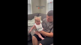 Baby girl's first encounter with apple sauce brings her smile and happiness