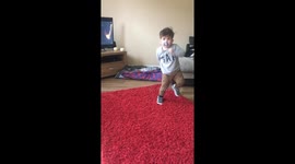 Little boy’s dancing comes to an end when dog pushes him to the floor
