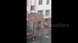 Shanghai man spotted taking BATH on flooded rooftop as Typhoon Bebinca lashes city