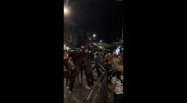 Person falls from horse after losing balance and toppling metal guard rail