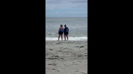 Woman Needs Help Up After Falling at the Beach