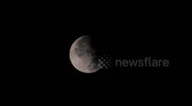 Partial eclipse of supermoon seen over Swiss Alps