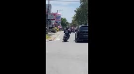 Motorcycle weaves between traffic with a wonky back wheel