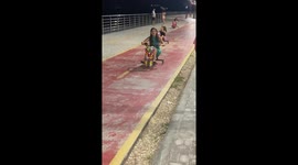 Person riding children's toy tricycle falls in Salinópolis, Brazil