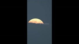 Mid-autumn full moon emerges from clouds