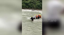 Officials rescue stranded cow from raging river in northern India