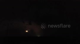 Lightning streaks across sky as supermoon visible above Canada