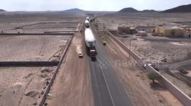 Drone footage shows convoy of huge plane parts being transported along road in Saudi Arabia