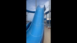 Woman gets silly on waterslide to bring laughter to her husband and son