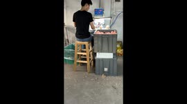 Factory Worker Loads Doll Heads