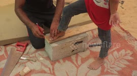 Palestinian carpenter makes wooden slippers for displaced Gazan children