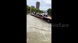 Convoy of excavators and trucks used to transport locals through flooded streets after Typhoon Bebinca hit eastern China
