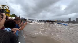 Tidal bore ripped phones out of tourists' hands as they watch from river banks in China