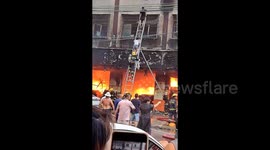 Firefighters help residents escape from apartment block blaze in southern China
