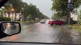 US: Fire Rescue Crews Navigate Flooded Streets to Aid Stranded Driver