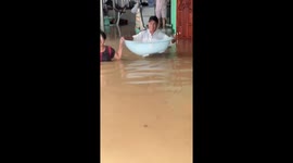 Baby carried to safety through floods in northern Thailand