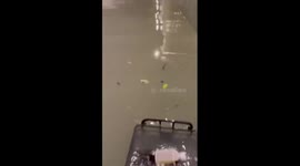 Cyclists ride through flooded tunnel in eastern China