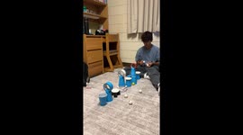 Bouncing a ping pong ball through tape rolls but it increases in difficulty after each make.