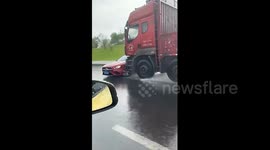 Shocking moment large truck pushes Mercedes down road in heavy rain as stunned female driver calls police