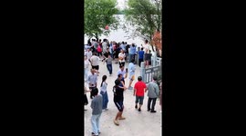 Giant waves smashes into tourists recording river.