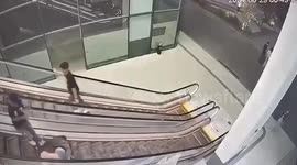 Jealous ex-girlfriend kicks lesbian lover's escort down moving escalator