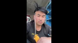 Mechanic styles his hair with fine wind blower
