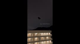 Pants on a hanger blown by wind hits person