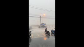Vendors cling to stall to stop it being blow away