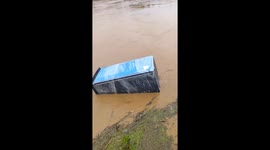 Fridge floats through flood after heavy rain
