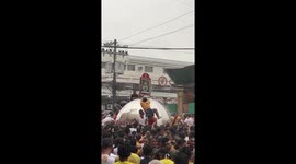 Catholics clamber to touch metal dome during procession