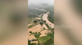 Paramotor flies over flooded area of northern Thailand