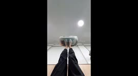 Chinese woman skillfully kicks drum while lying on the floor