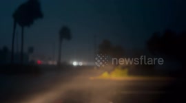 Power lines explode in the distance during Hurricane Helene