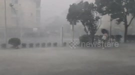 Man blown over by typhoon Bebinca in Shanghai