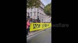 UK: Protesters with a huge banner outside 10 Downing Street on the first anniversary of Rosebank's approval