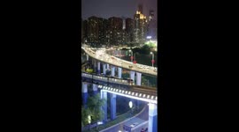 Nightscape of metro trains gliding through China's Chongqing