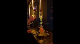 Bartender creates flaming tower of glasses