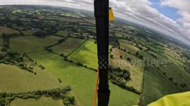 Terrifying moment paraglider breaks back after plummeting to ground, incident captured by fellow pilot