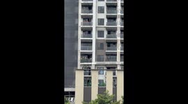 Builders working on high-rise condo block watch concert for free