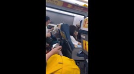 Train passengers fight for window blinds