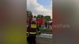 Firemen douse Thai school bus fire wreckage in which '13 pupils were burned alive'